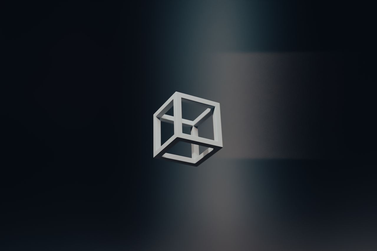 A minimalistic 3D cube floating in a dark space, creating an abstract art theme.